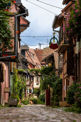 Fototapeta premium Old half-timbered houses in the historic medieval old town of Eguisheim in Alsace and on Alsace Wine Route, Haut-Rhin, Grand Est, France, Europe