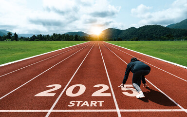 New year resolution 2025 concept. Word start 2025 written on athletics track and athlete woman...