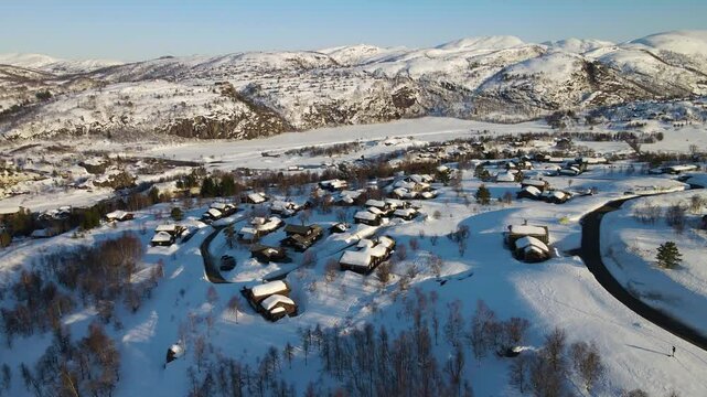 Aerial Drone Shot of Snow-Covered Winter Mountains and Cabins in Sinnes, Sirdal, Agder, Norway