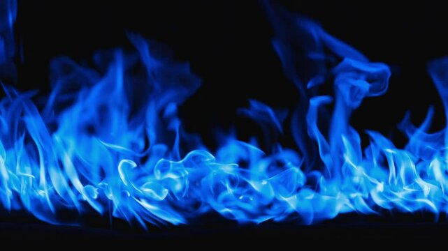 Gas burns with a bright blue flame. Beautiful dancing fire, Lots of fire. Blue fire is burning. Bright blue flames. A wall of real fire, abstract background. Super-slow motion video