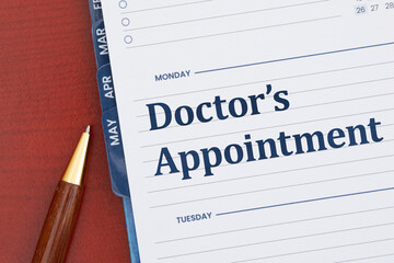 Doctors appointment on day planner on desk