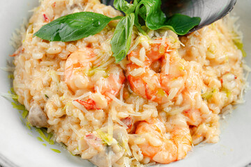 Portion of seafood risotto with mussel shells