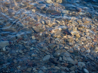 Sea Travel. Sea Foam Surf And Shiny Multi-Colored Pebbles. Background Of Sea Water. Bokeh.