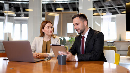 Businessman and a businesswoman working together on some business project