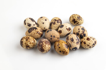 Fototapeta premium Pile of Raw Quail eggs isolated on white, side view
