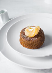 mini vanilla bundt cakes on a white plate, vanilla bundlette with icing sugar on a white background, homemade small vanilla bundt cakes