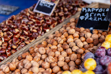 Rich textures and colors come to life in a lively market, featuring an array of fresh nuts and dried fruits. This autumnal assortment invites visitors to savor the local harvest's delights.