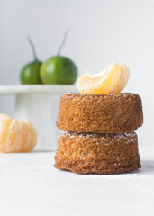 A stack of mini vanilla cakes, vanilla bundlette stacked on a white background, homemade small vanilla bundt cakes