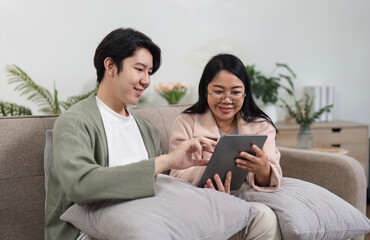 Mother and Son Relaxing Together in Modern Living Room, Enjoying Quality Time with Digital Tablet