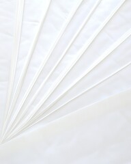 A minimalist arrangement of white sheets and lines creating a serene, abstract composition.