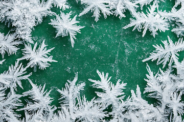 Frosty Christmas background with ice crystals forming intricate patterns on a blue surface