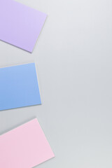 Top view of pink, purple and blue notebooks on grey background. School, office wallpaper. Flat lay, copy space.