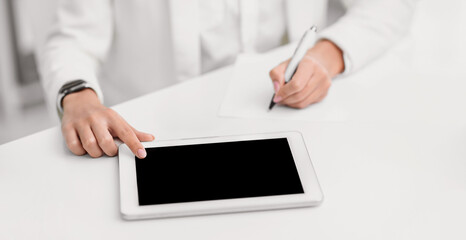 Writing Ideas. Unrecognizable woman using touch tablet and taking notes. Mock up