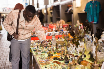 Man chooses antiques at a flea market