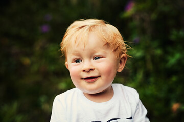 Smile, boy and child thinking outdoor in garden for game, playing and relax on holiday in nature. Park, young toddler and happy kid daydreaming on vacation, adorable and cute in summer on weekend
