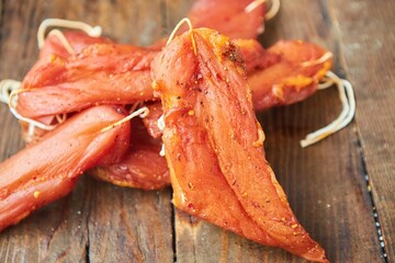 Dried meat lies on a wooden surface. Meat production.