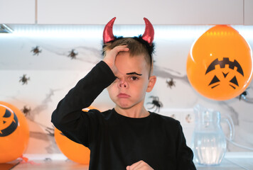 Halloween at home. Boy is ready for Trick or Treat party. Portrait of child in suit, ready for...