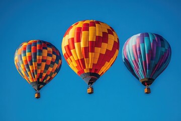 Obraz premium Colorful hot air balloons soaring high in the clear blue sky during a sunny day