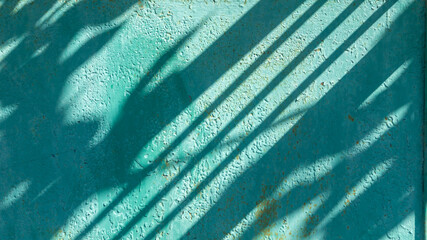 Shadows on an iron surface covered with paint. The iron surface is covered with green paint with...