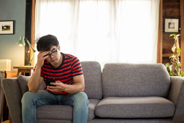 Obraz premium sad depression serious people from work,study stress problem.asian man feeling tired suffering using cell phone working work place.concept global economic,health problems