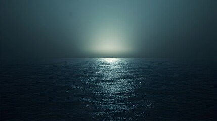 Obraz premium Peaceful and serene landscape of a vast dark midnight ocean under a dramatic night sky with the first light of dawn slowly breaking over the distant horizon and casting a faint glow over the tranquil