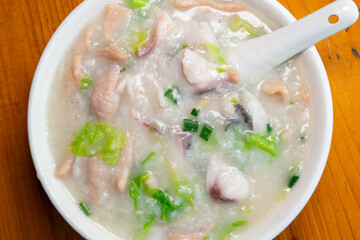 top view fish slices and pork porridge at horizontal composition