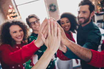 Photo of cheerful young people colleagues give highfive support cozy christmas party decor spacious office indoors