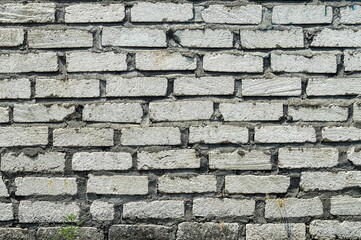 Gray brick wall with subtle color variations and natural patterns, perfect for backgrounds or design elements.