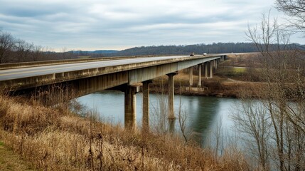 Fototapeta premium An expansive highway bridge crossing over a river, surrounded by nature and no signs of human activity