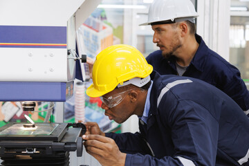 head technician engineer consulting and discussing operations new machine technology to work in production line to factory worker. .