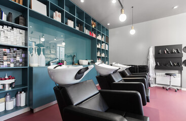 Interior of european beauty salon. Hairdresser places and many professional cosmetics on shelves