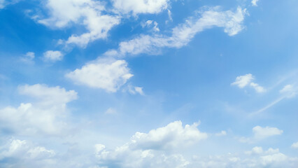 Bright clear blue sky and fluffy clouds. Sunny day and refreshing weather.