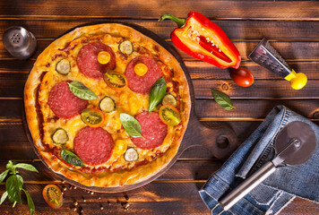 Tasty pepperoni pizza with basil on wooden table