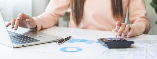 Deduction planning, debt asian young woman  hand using laptop computer, calculator calculating...