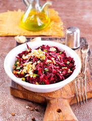 beetroot salad with walnut in a plate on dark background