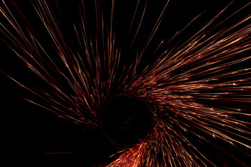 Obraz premium red sparks from the grinder glowing in the dark