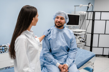 Female doctor gastroenterologist calming his male patient man before the gastroscopy procedure at...