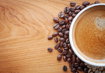 Crema espesso coffee cup, espresso  coffee and coffee bean on wooden table