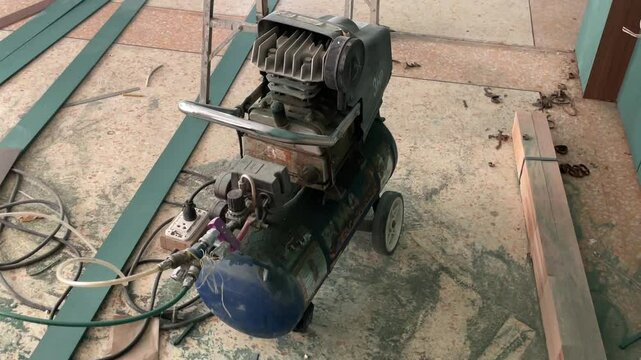 air pump,Air compressor in car mechanic workshop. Old round air compressor in mechanic workshop