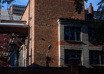 An old technical building made of brick in the industrial area of ​​the city.