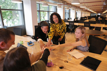 Business people stacking hands in office