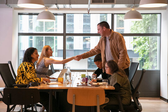 Business people shaking hands in office