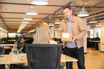 Man delivering package in office