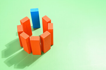 Blue wooden block placed in between the orange blocks.