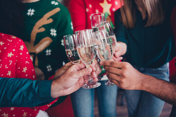 Cropped photo of nice young people team employees toast champagne enjoy cozy christmas decoration interior office indoors corporate party