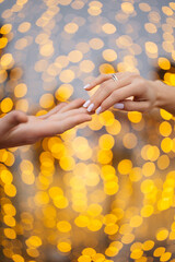 hands of a married couple on a bokeh background