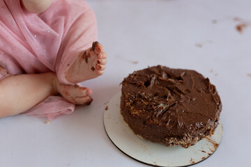 children's foot near the birthday cake