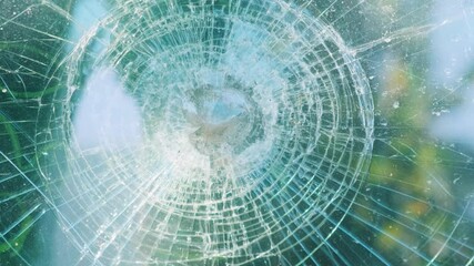 Close-up of shattered glass with intricate radial cracks forming circular pattern, creating an abstract and textured effect with light reflections. Broken car glass of windscreen. Car accident - Powered by Adobe