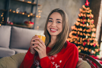 Photo of lovely cheerful girl drink cacao hold mug dressed red christmas garment tradition atmosphere decor vibe house indoors room