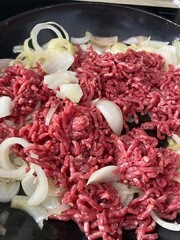 close-up of raw minced meat with onions, food texture 